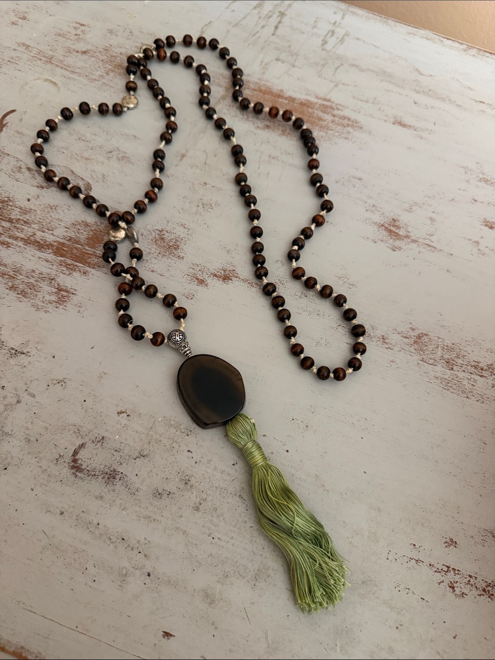 Long Brown Bead Necklace with Green Tassel Pendant